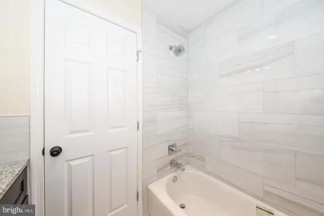 a bathroom with a tub and shower