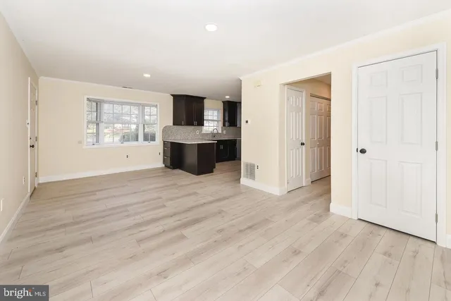 a view of kitchen with wooden floor electronic appliances and window