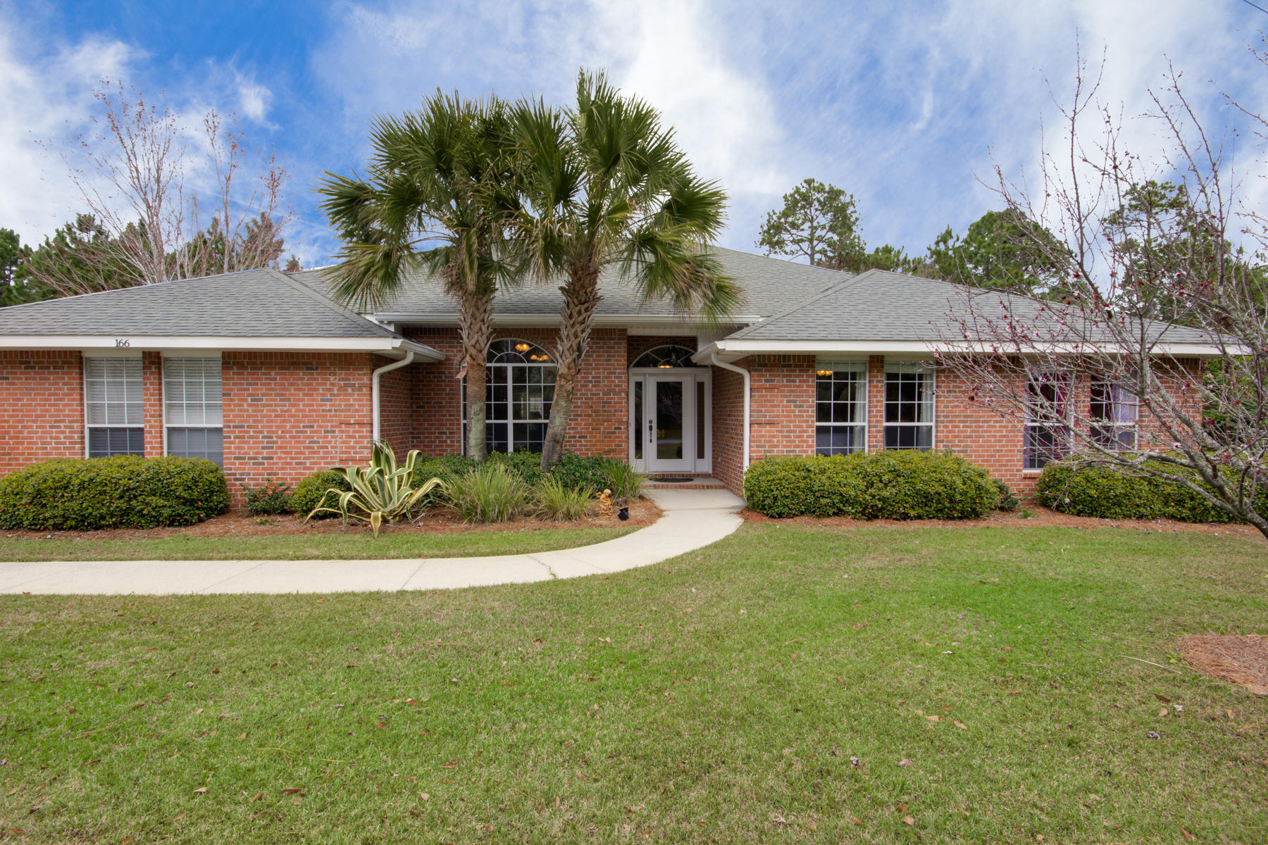 166 East Shipwreck Road Santa Rosa Beach, FL 32459 - Photo 1 of 33 a front view of a house with yard and green space