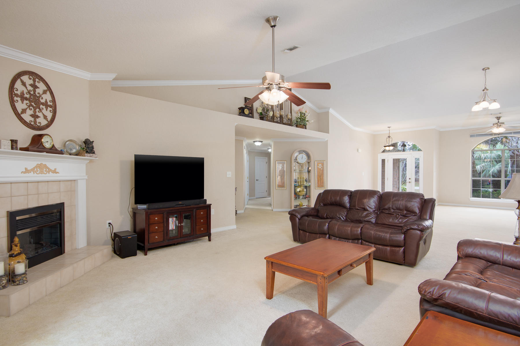166 East Shipwreck Road Santa Rosa Beach, FL 32459 - Photo 6 of 33 a living room with furniture a flat screen tv and a fireplace