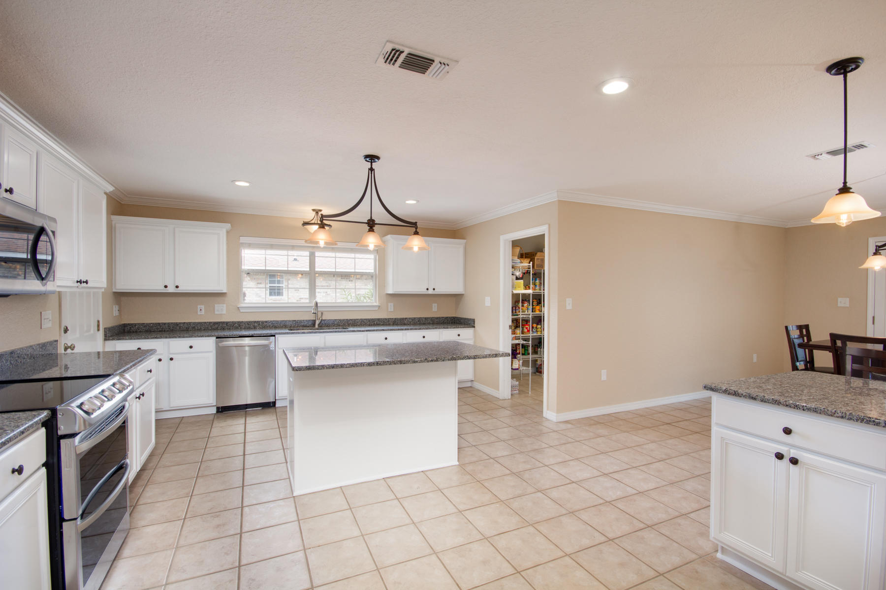 166 East Shipwreck Road Santa Rosa Beach, FL 32459 - Photo 7 of 33 a kitchen with granite countertop white cabinets and white appliances