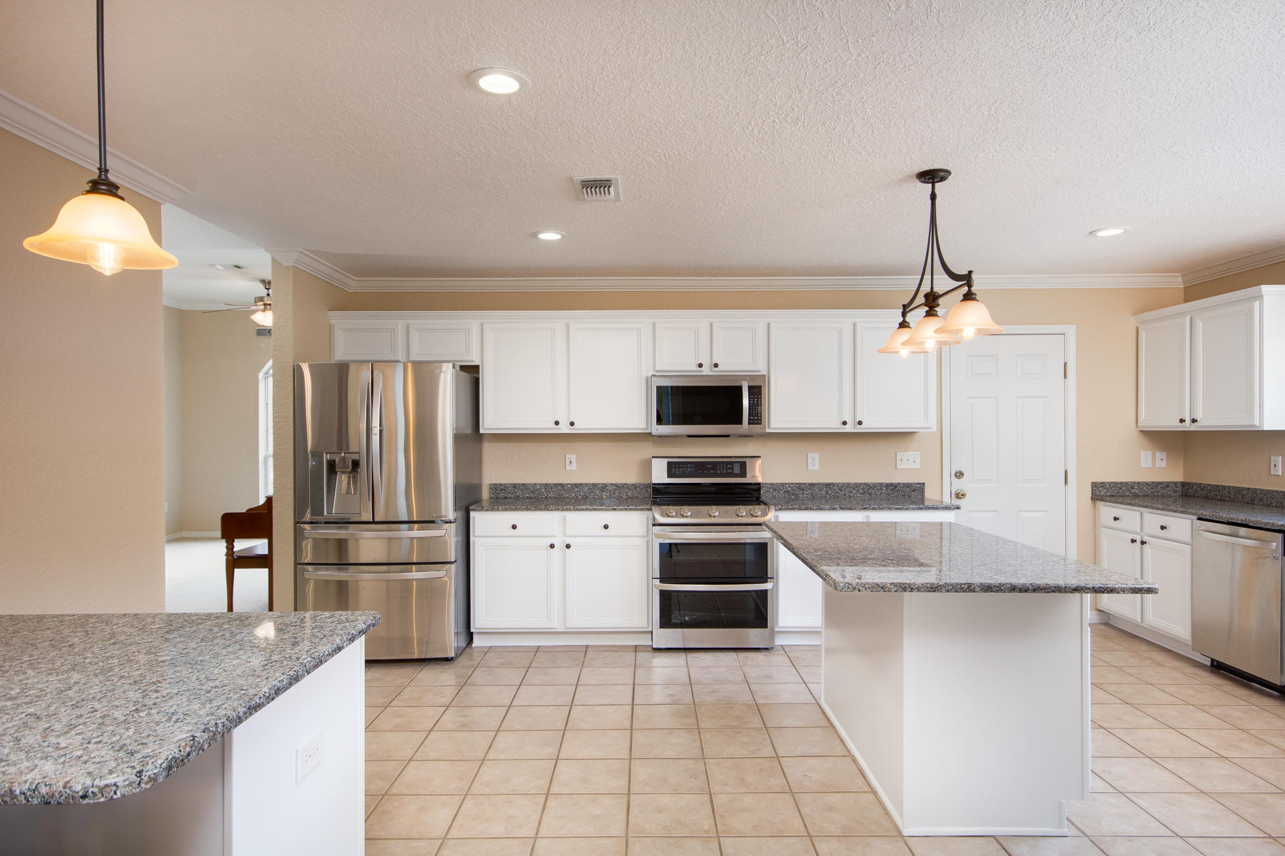 166 East Shipwreck Road Santa Rosa Beach, FL 32459 - Photo 8 of 33 a kitchen with stainless steel appliances granite countertop a sink a stove top oven a refrigerator and cabinets
