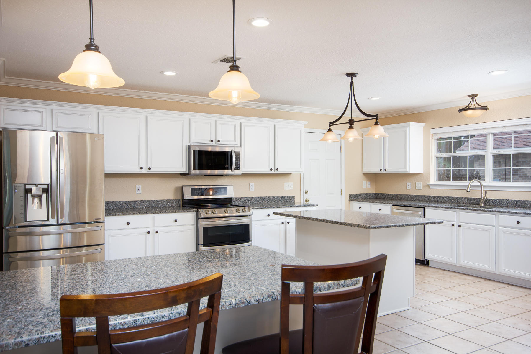 166 East Shipwreck Road Santa Rosa Beach, FL 32459 - Photo 10 of 33 a kitchen with stainless steel appliances granite countertop a stove refrigerator sink and cabinets