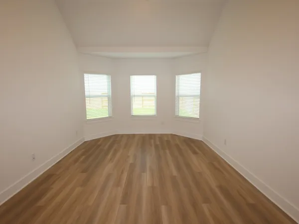 a front view of a house with a garden and yard