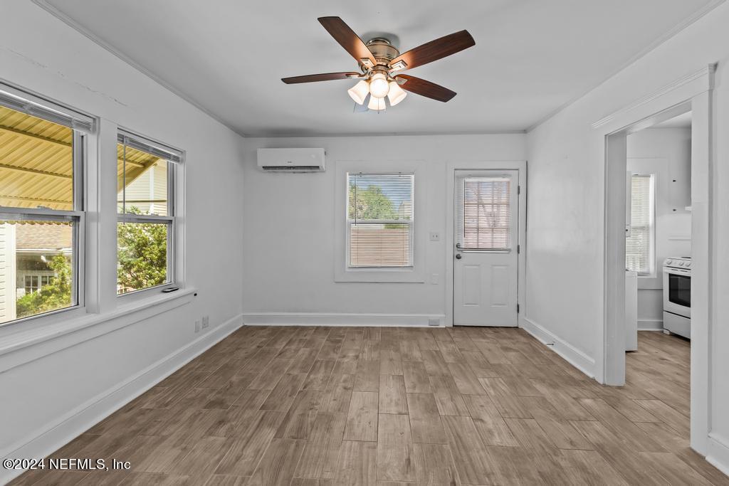 313 A St George Street St. Augustine, FL 32084 - Photo 17 of 21 an empty room with wooden floor and windows