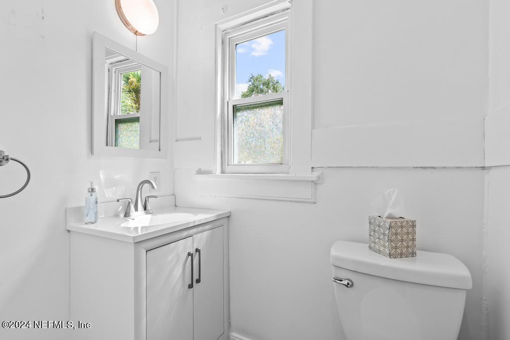 313 A St George Street St. Augustine, FL 32084 - Photo 19 of 21 a bathroom with a sink a toilet and mirror