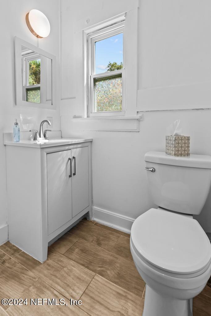 313 A St George Street St. Augustine, FL 32084 - Photo 20 of 21 a bathroom with a toilet sink and mirror