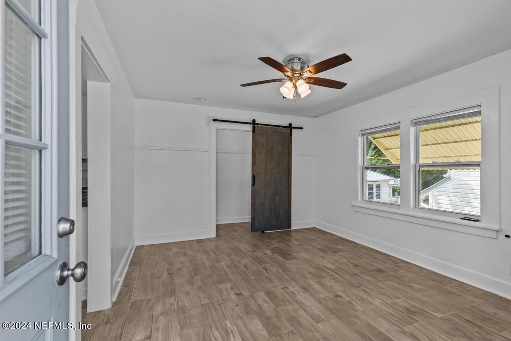 313 A St George Street St. Augustine, FL 32084 - Photo 3 of 21 wooden floor in an empty room with a window