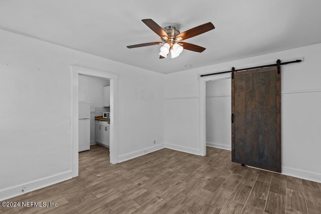313 A St George Street St. Augustine, FL 32084 - Photo 7 of 21 a view of a livingroom with wooden floor and a ceiling fan