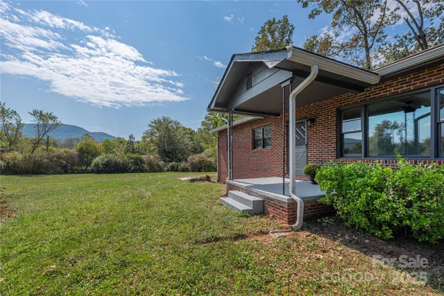 a view of a wooden house with a yard