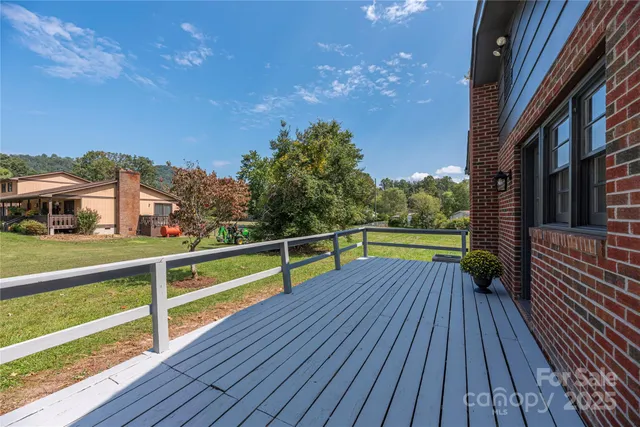 a view of balcony with wooden floor and fence