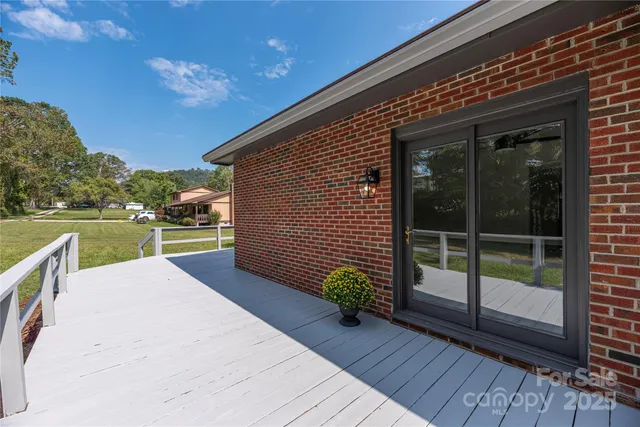 a view of a backyard with plants and wooden fence