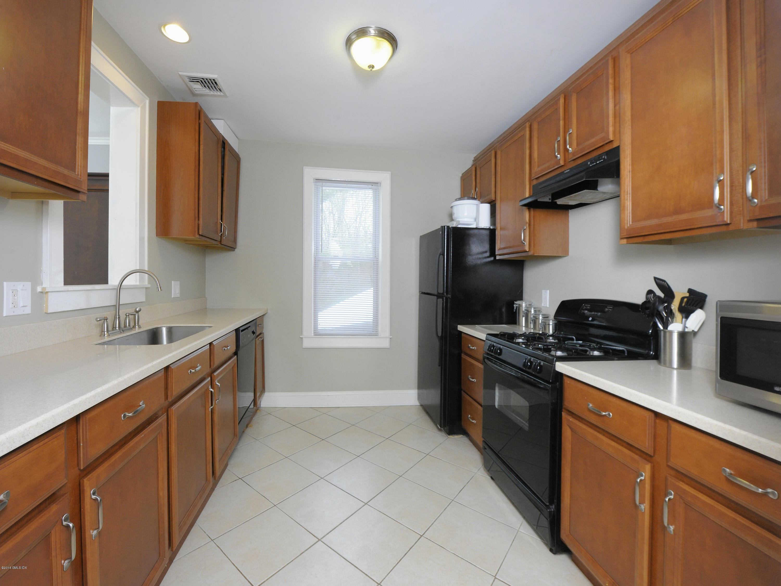 44 Riversville Road Greenwich, CT 06831 - Photo 12 of 19 a kitchen with stainless steel appliances granite countertop a sink stove and refrigerator