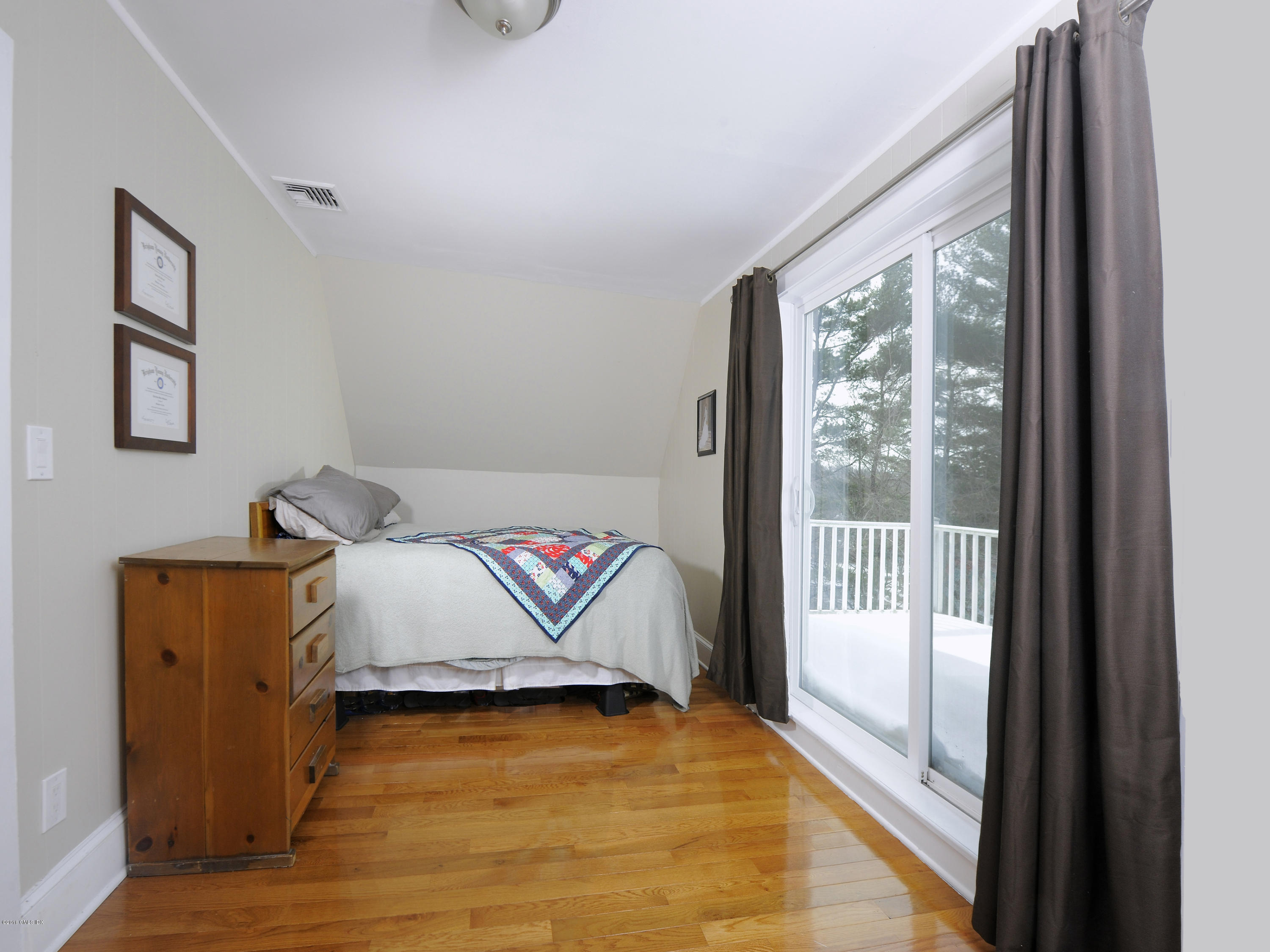 44 Riversville Road Greenwich, CT 06831 - Photo 14 of 19 a living room with a bed and wooden floor