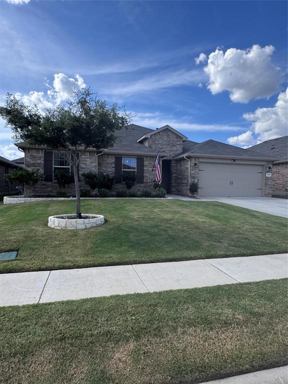 1908 Cookes Lane Cleburne, TX 76033 - Photo 17 of 17 Stone and brick facade with dark shutters, an attached two-car garage, and a concrete driveway