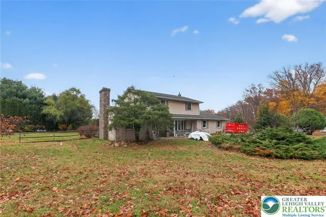 a view of a house with a yard and sitting area