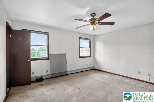 a view of a livingroom with a window and a ceiling fan
