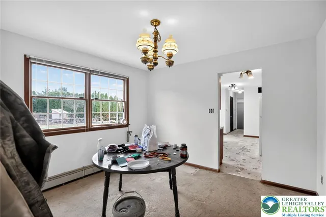 a view of a room with a chandelier furniture and windows