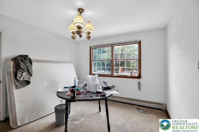 a room with a table and a chandelier