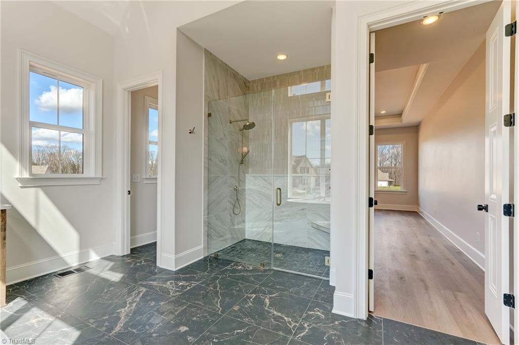 7688 Kyran Court Oak Ridge, NC 27310 - Photo 17 of 40 Elegant tiled, zero entry walk in shower