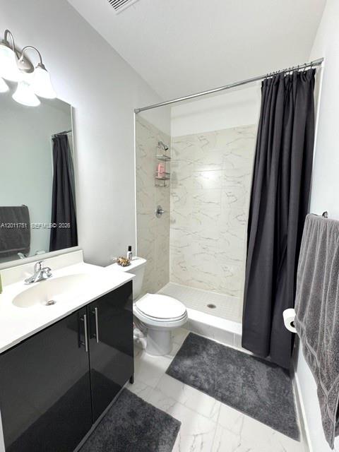 15650 Southwest 136th Street, Unit 101 Miami, FL 33196 - Photo 11 of 16 a bathroom with a sink a toilet a mirror and shower