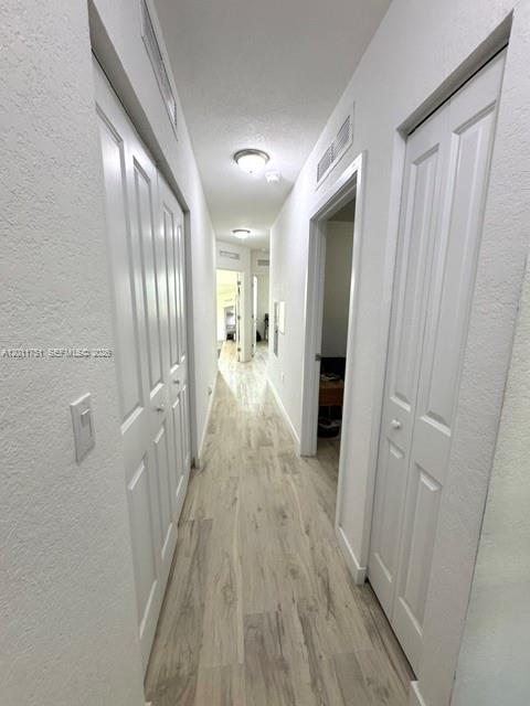 15650 Southwest 136th Street, Unit 101 Miami, FL 33196 - Photo 12 of 16 a view of a hallway with wooden floor