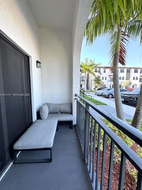 15650 Southwest 136th Street, Unit 101 Miami, FL 33196 - Photo 14 of 16 a view of a living room and a balcony
