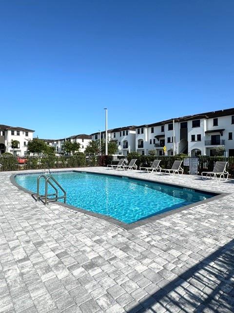 15650 Southwest 136th Street, Unit 101 Miami, FL 33196 - Photo 15 of 16 a view of a swimming pool with a lawn chairs