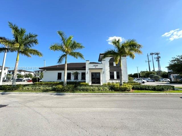 15650 Southwest 136th Street, Unit 101 Miami, FL 33196 - Photo 16 of 16 a front view of a house with a garden