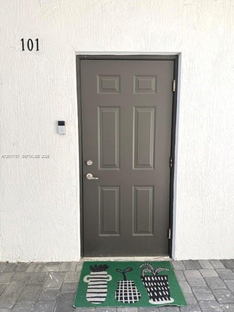 15650 Southwest 136th Street, Unit 101 Miami, FL 33196 - Photo 2 of 16 a view of a wooden door