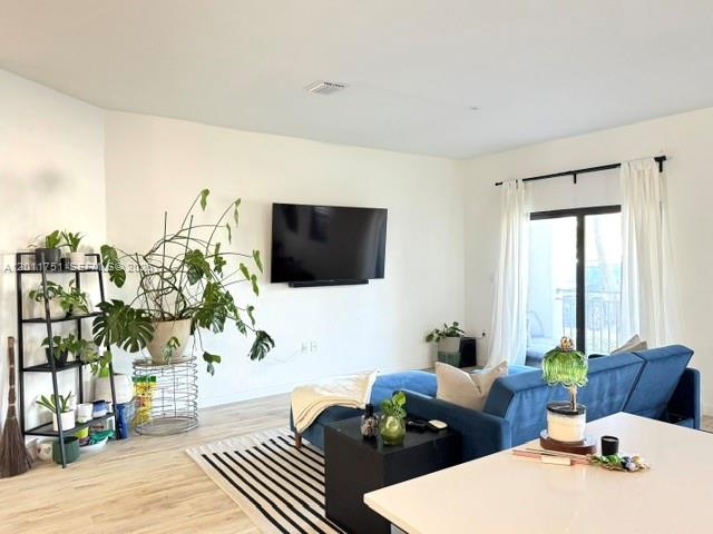 15650 Southwest 136th Street, Unit 101 Miami, FL 33196 - Photo 3 of 16 a living room with furniture fireplace and flat screen tv