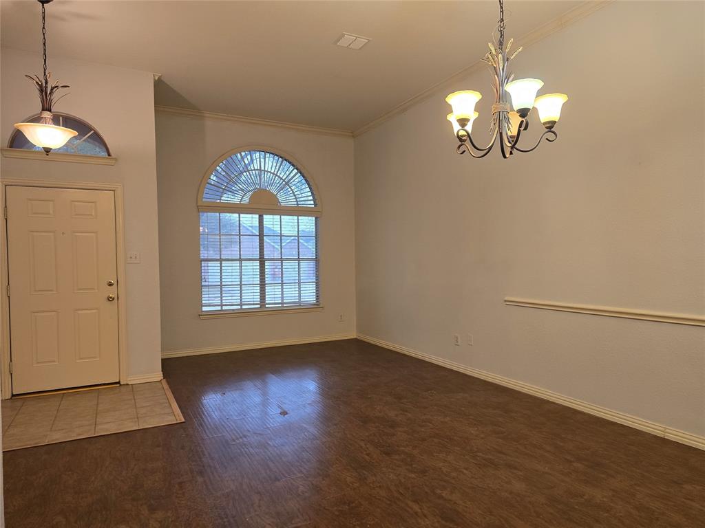 100 Bryan Street Prosper, TX 75078 - Photo 7 of 18 a view of a livingroom with a chandelier fan windows and wooden floor