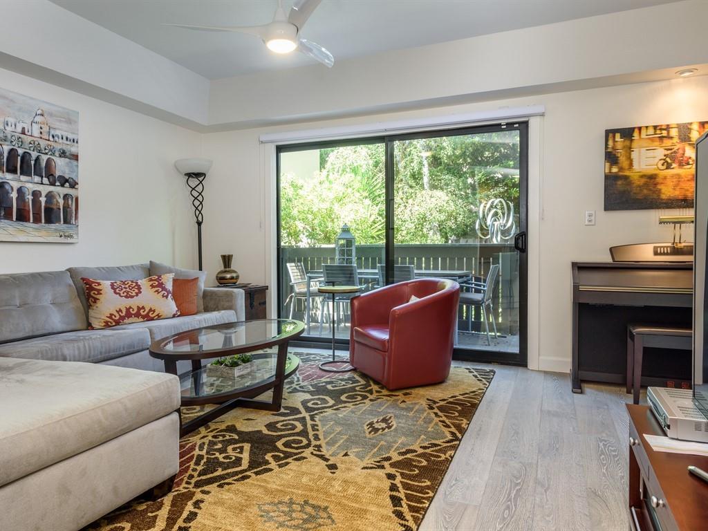 616 Ansel Road, Unit 2 Burlingame, CA 94010 - Photo 8 of 15 a living room with furniture a rug and a floor to ceiling window