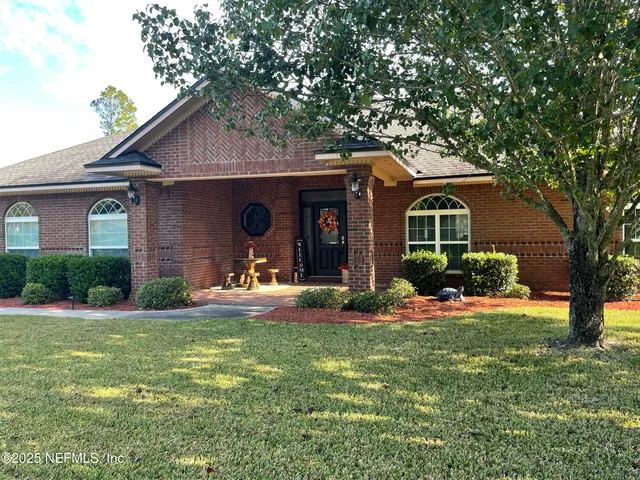 a front view of a house with a yard