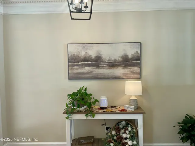 a room with a table and a potted plant