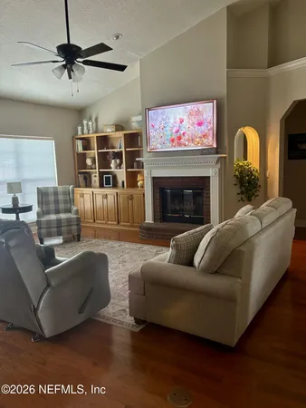 a living room with furniture and a fireplace