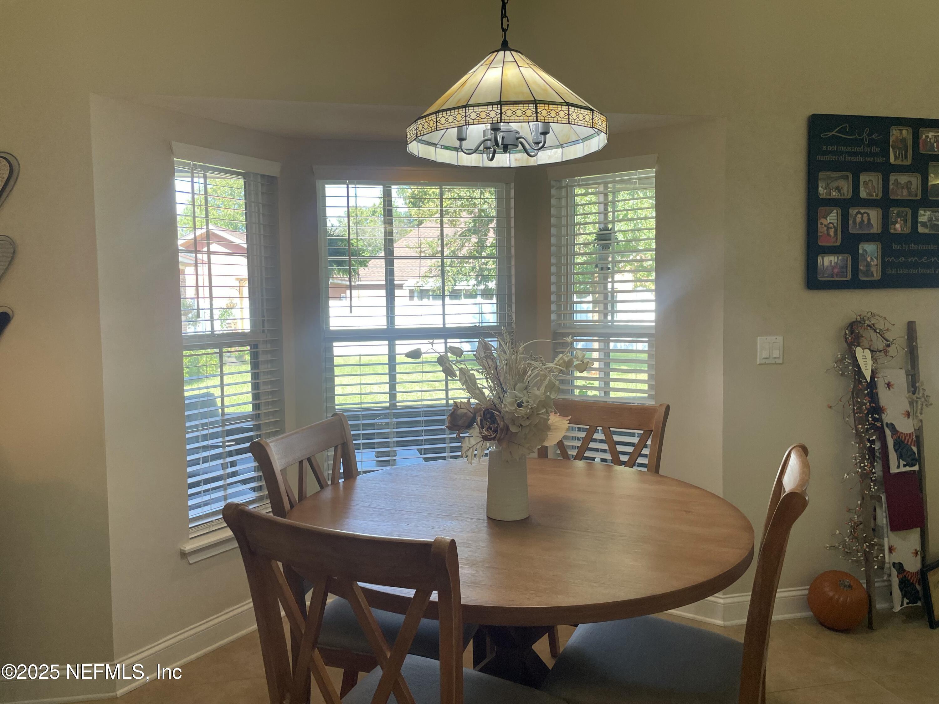1168 Copper Gate Place Macclenny, FL 32063 - Photo 24 of 44 a view of a dining room with furniture window and outside view
