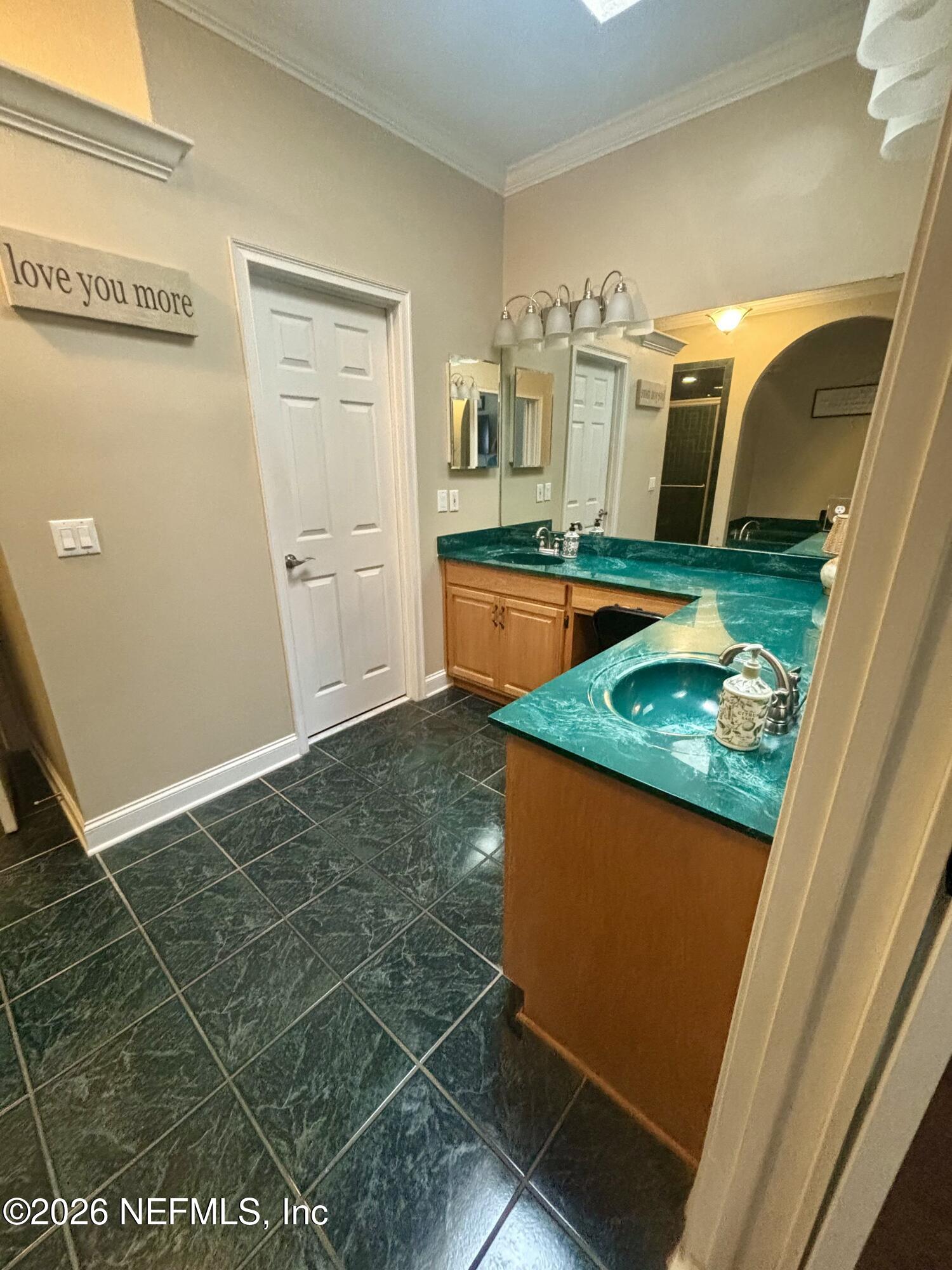 1168 Copper Gate Place Macclenny, FL 32063 - Photo 24 of 51 a kitchen with stainless steel appliances granite countertop a sink and a view of living room