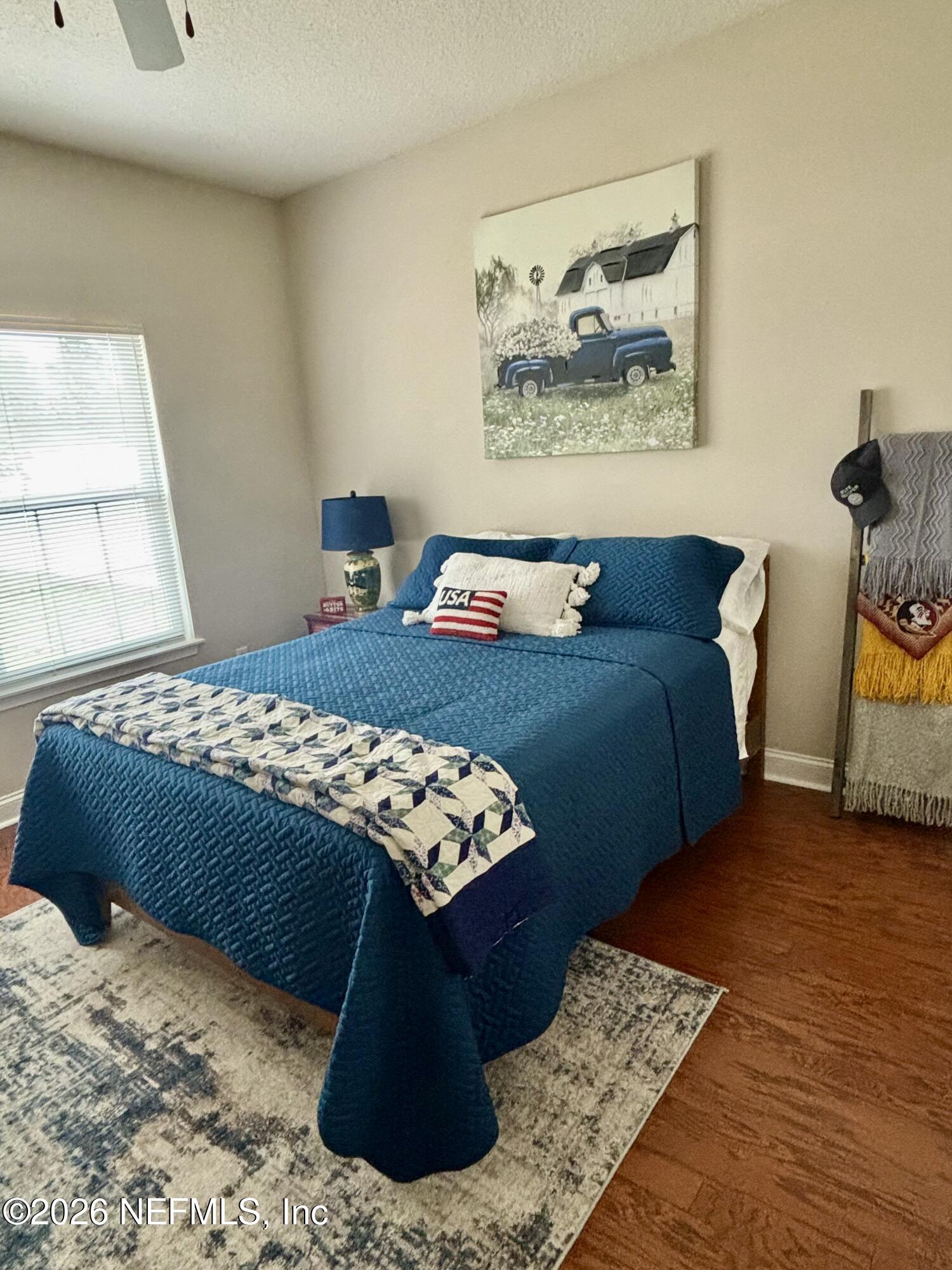 1168 Copper Gate Place Macclenny, FL 32063 - Photo 27 of 51 a bedroom with a bed and a painting on the wall