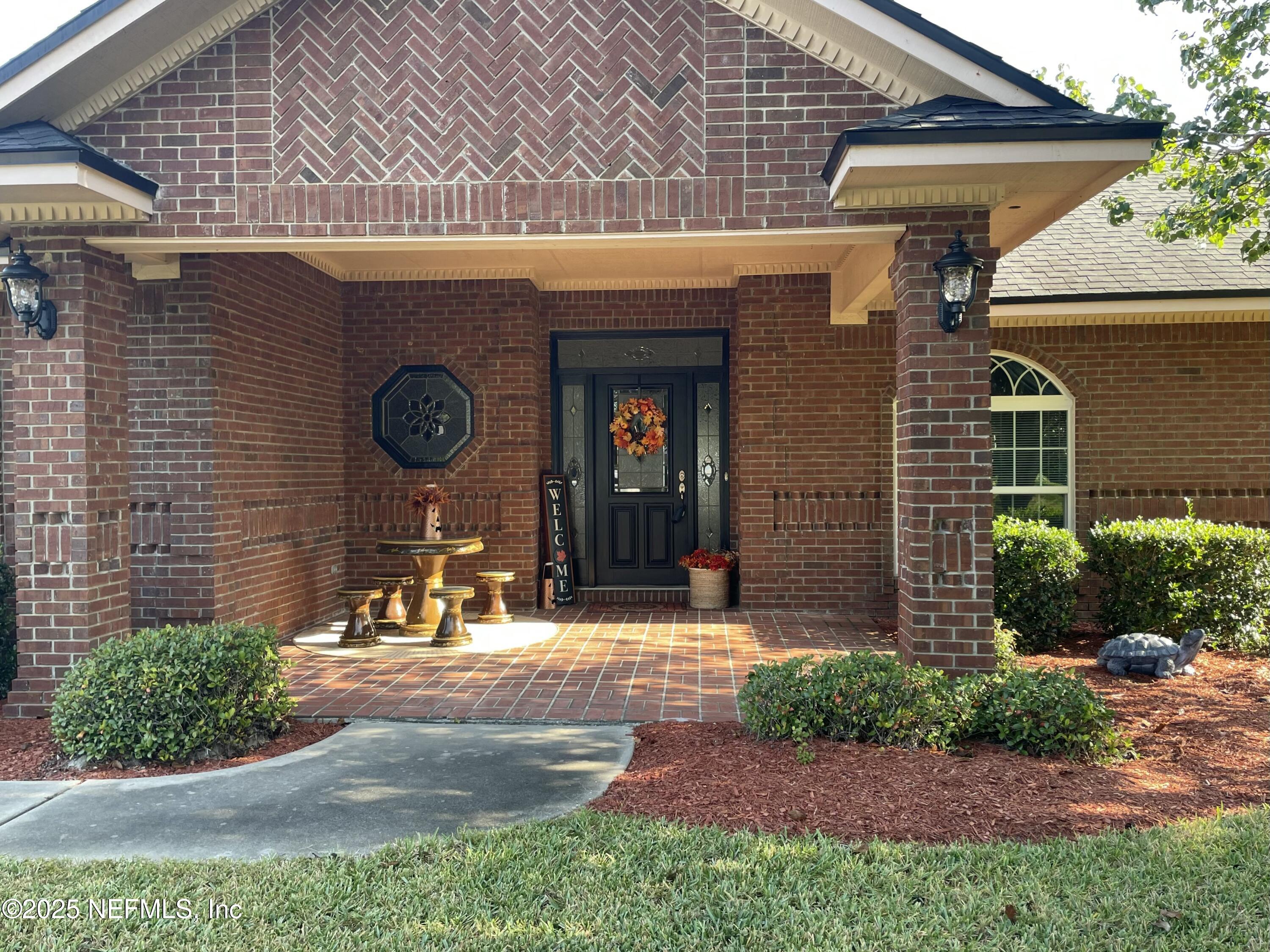 1168 Copper Gate Place Macclenny, FL 32063 - Photo 3 of 44 a front view of a house with garden