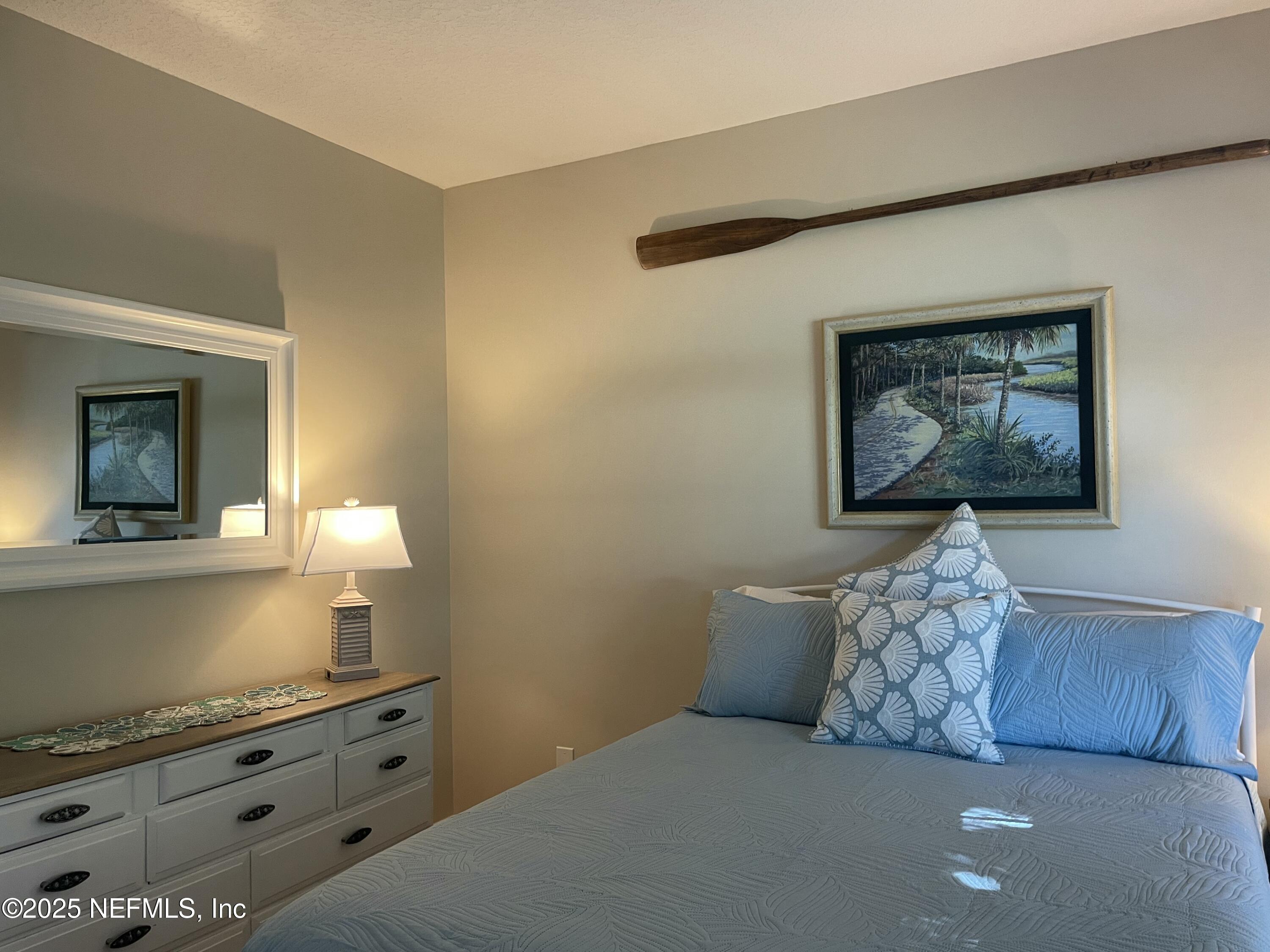 1168 Copper Gate Place Macclenny, FL 32063 - Photo 34 of 44 a bedroom with a bed and a dresser