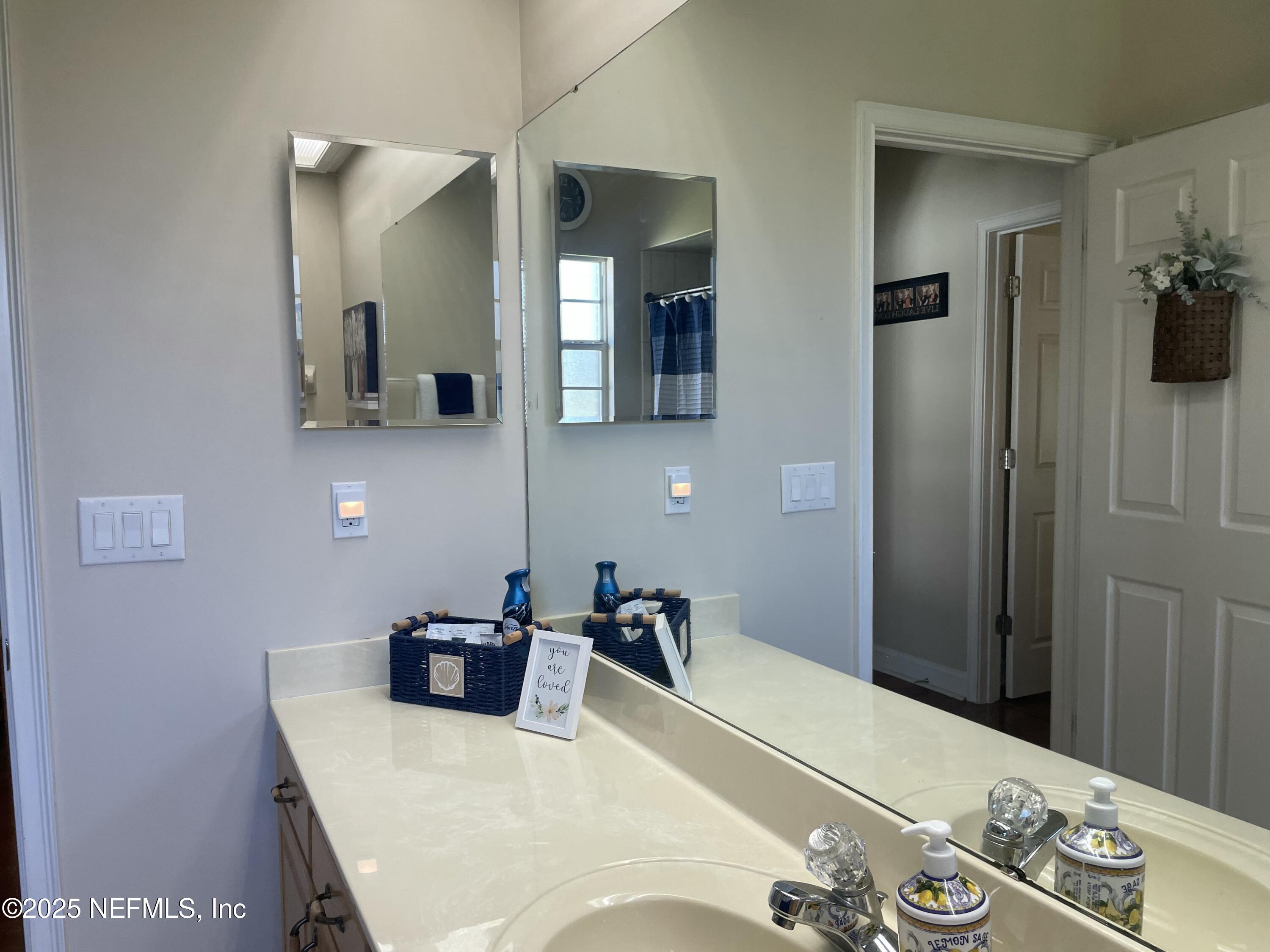 1168 Copper Gate Place Macclenny, FL 32063 - Photo 36 of 44 a bathroom with a sink vanity and mirror