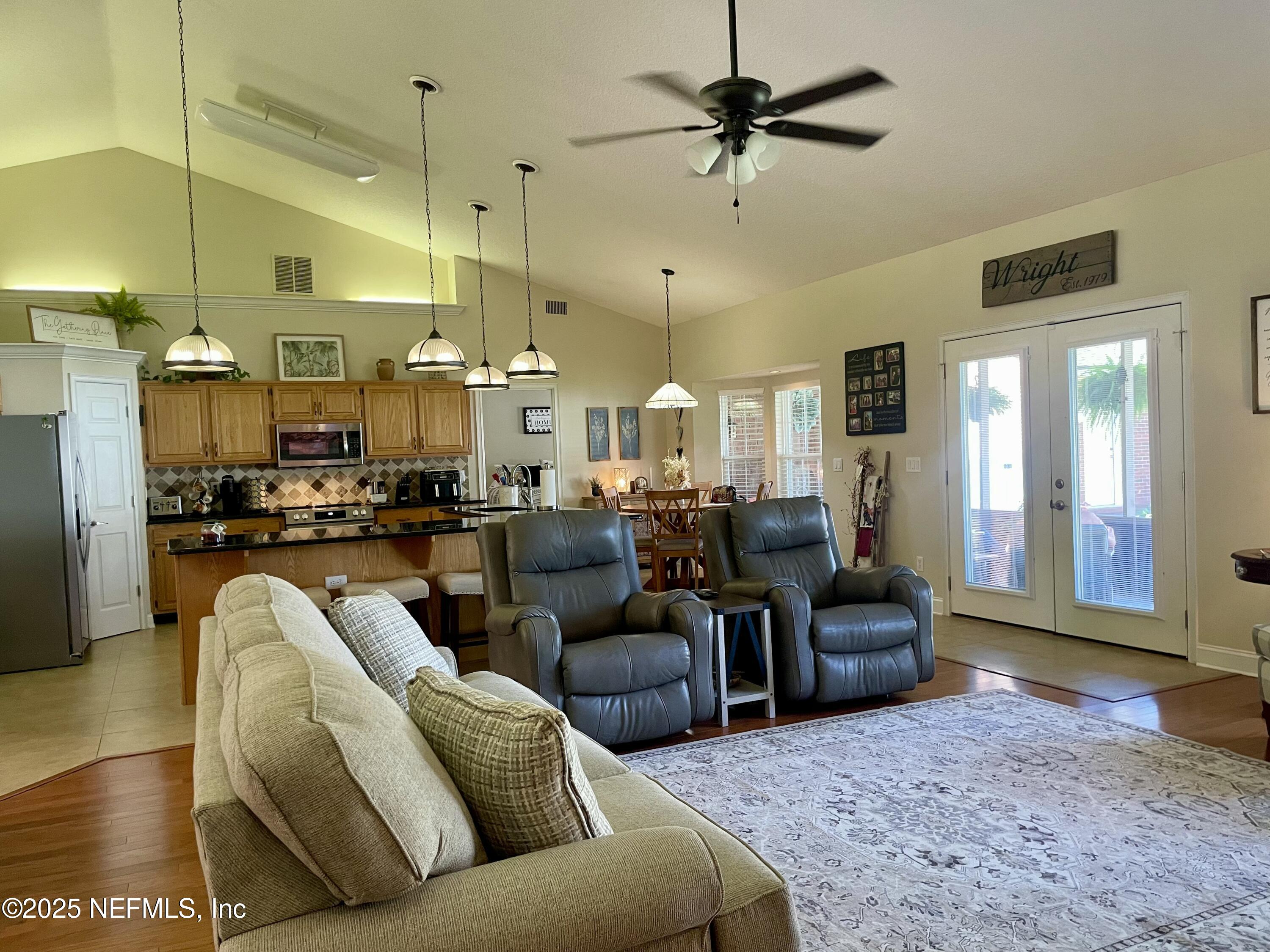 1168 Copper Gate Place Macclenny, FL 32063 - Photo 37 of 51 a living room with furniture kitchen view and a chandelier