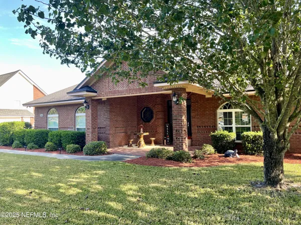 a kitchen with granite countertop a stove top oven microwave and cabinets