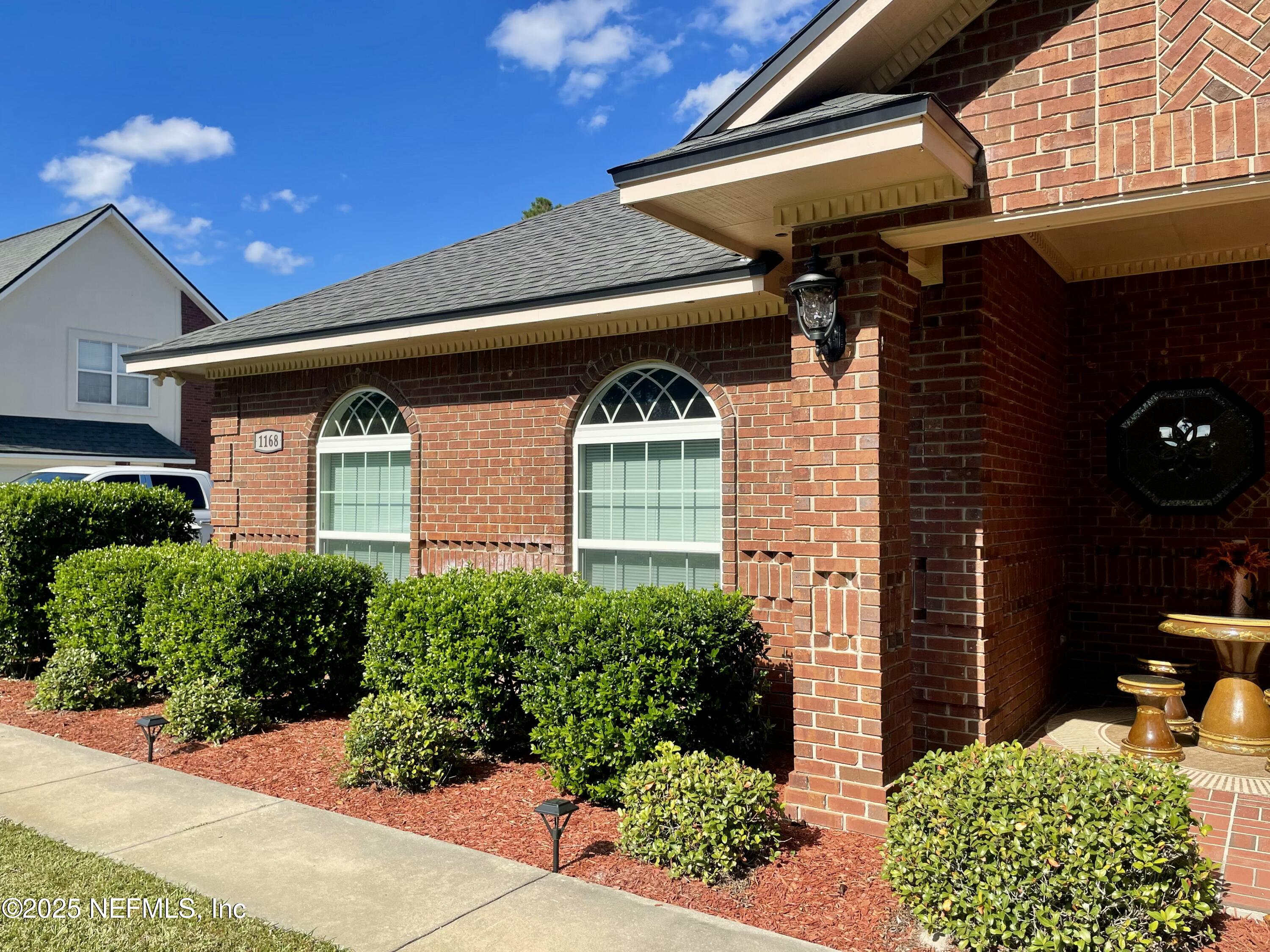 1168 Copper Gate Place Macclenny, FL 32063 - Photo 5 of 44 a front view of a house with a garden