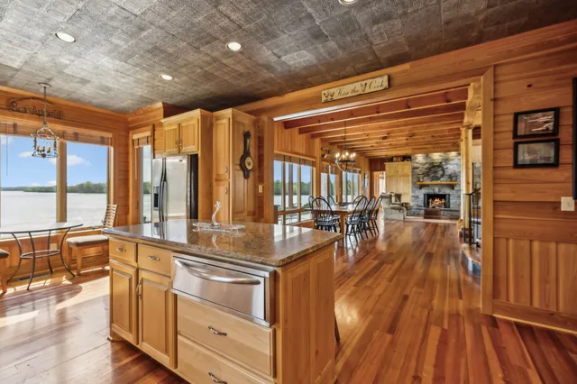 a very nice looking room with wooden floor and large windows