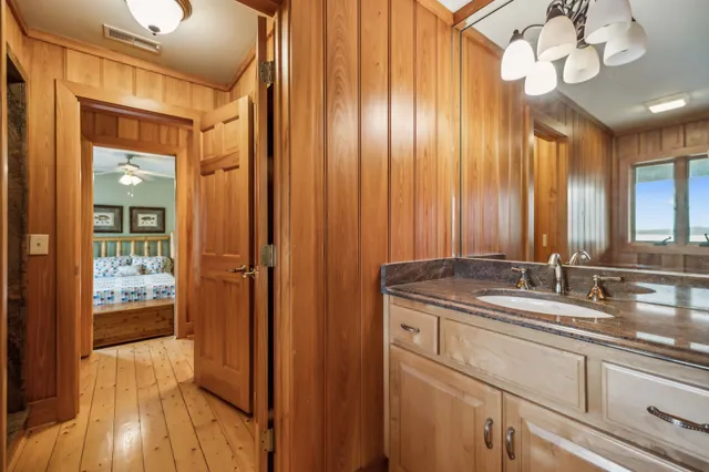 a bedroom with a bed and a flat tv screen on dresser