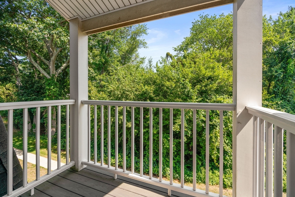 47 Will Drive, Unit 114 Canton, MA 02021 - Photo 12 of 25 a view of a wooden deck next to a yard