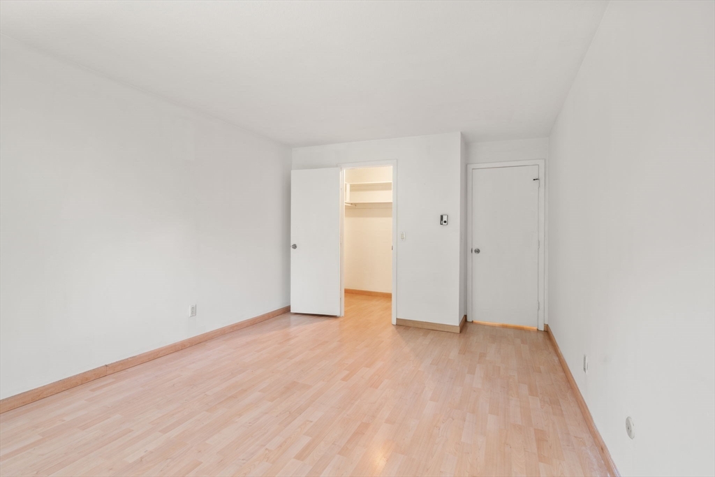 47 Will Drive, Unit 114 Canton, MA 02021 - Photo 14 of 25 a view of an empty room with wooden floor and closet