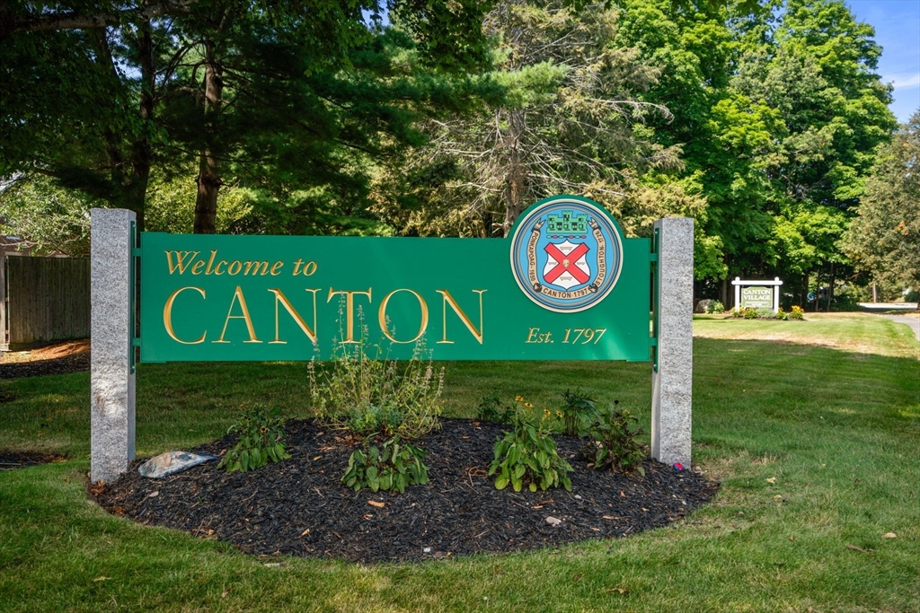 47 Will Drive, Unit 114 Canton, MA 02021 - Photo 2 of 25 a sign that is sitting on a green field